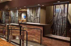 A wide view of the custom textured glass partition walls and custom waterjet cut screens at the Kankakee Grille, by Archetype Glass