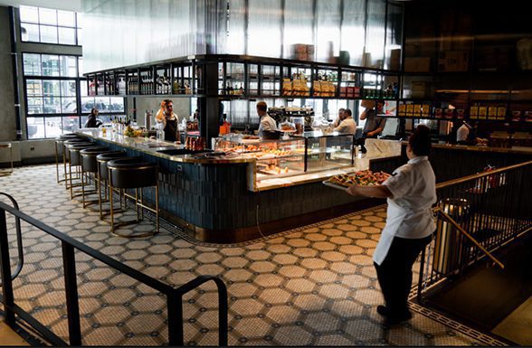 Archetype Glass' textured art glass is used in the custom glass shelves at the Officina Cafe