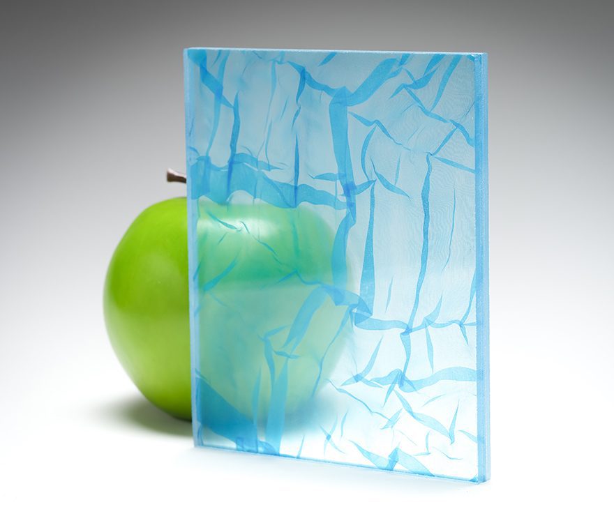 A light blue highly transparent sample of the new custom laminated fabric glass created in coordination with Spatial Element.