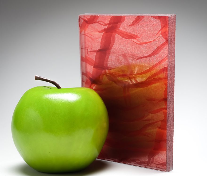 A red mirrored sample of the new custom laminated fabric glass in coordination with Spatial Element.