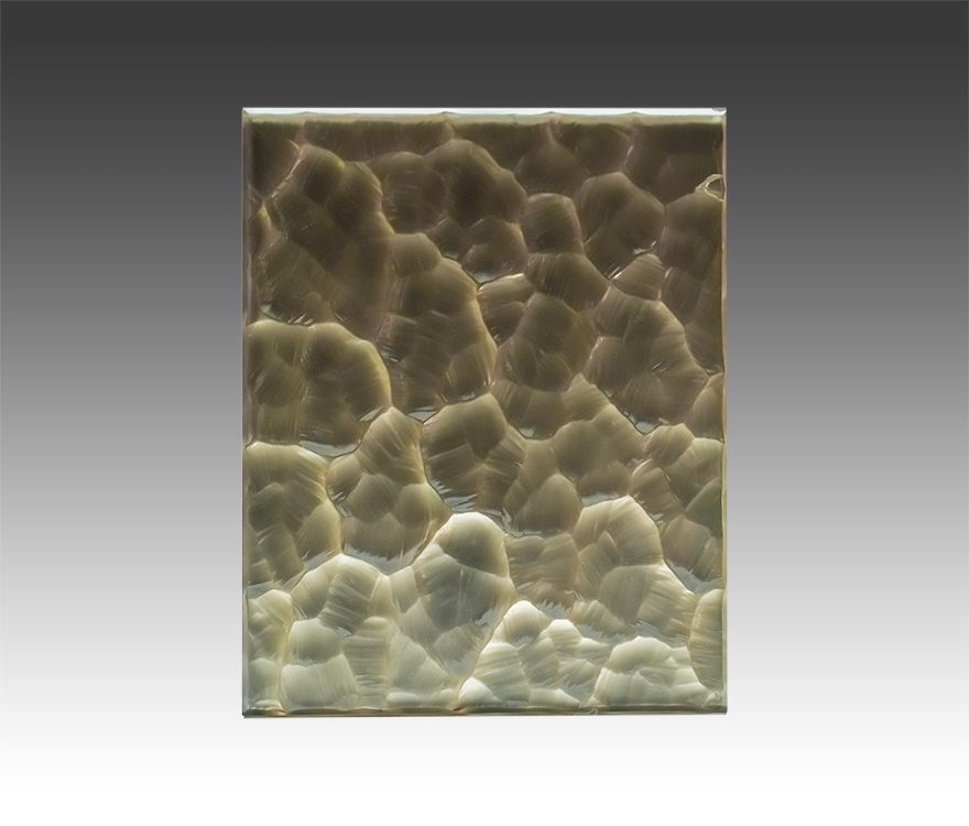A scalloped gold custom laminated mirror as part of the Fourth Quarter Collection from Archetype Glass