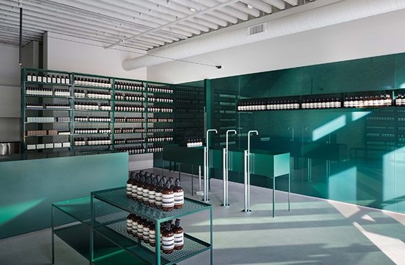 New York City's Aesop West retail space, featuring a stunning monochromatic custom wall cladding treatment incorporating Archetype Glass' custom laminated color glass